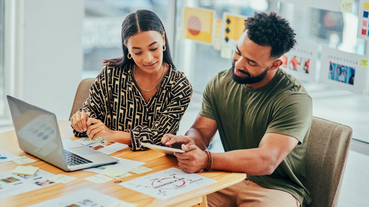 Two creators reviewing a campaign together on a laptop